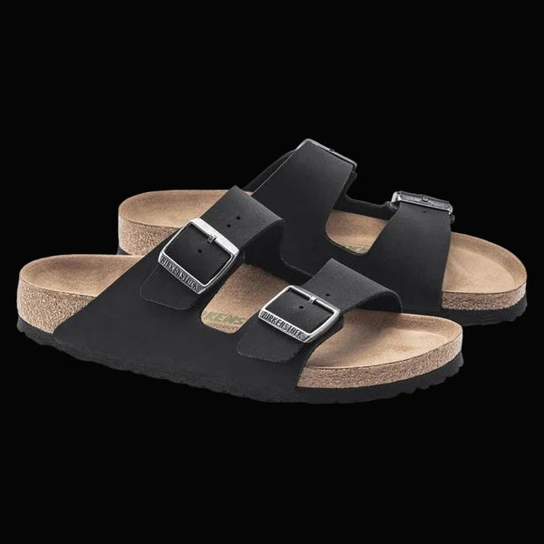 Black sandals with cork soles on a white background